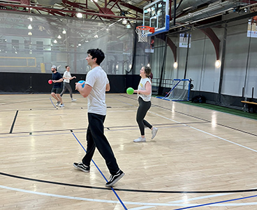 Bluestar team members getting exercise on gym court