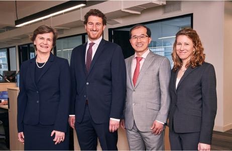  Bluestar leadership team Trzcinska, Eskow, Zhang, and Olsen standing together in new office space